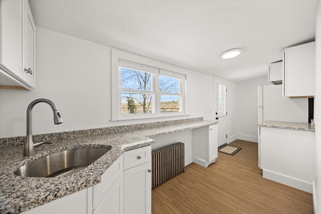 8 Herring Pond Road Bourne, MA 02532 - Photo 26 of 42 a kitchen with a sink cabinets a counter top space and stainless steel appliances