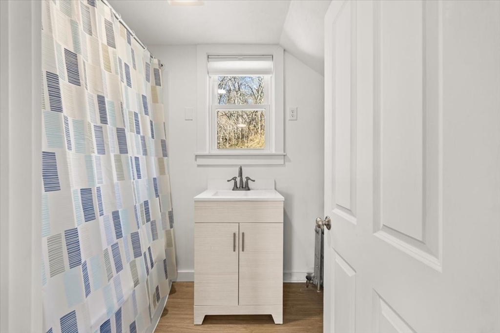 8 Herring Pond Road Bourne, MA 02532 - Photo 28 of 42 a bathroom with a sink a mirror and a shower curtain