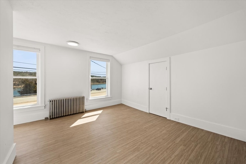 8 Herring Pond Road Bourne, MA 02532 - Photo 29 of 42 an empty room with wooden floor and windows