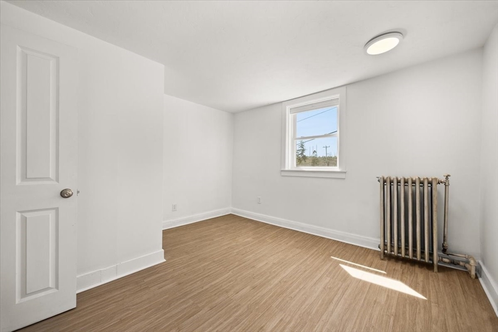 8 Herring Pond Road Bourne, MA 02532 - Photo 31 of 42 an empty room with wooden floor and windows