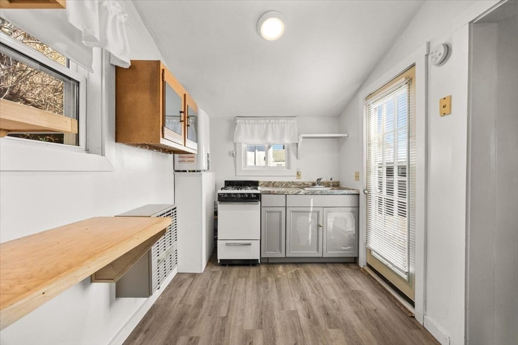 8 Herring Pond Road Bourne, MA 02532 - Photo 33 of 42 a kitchen with a sink a stove a refrigerator and cabinets