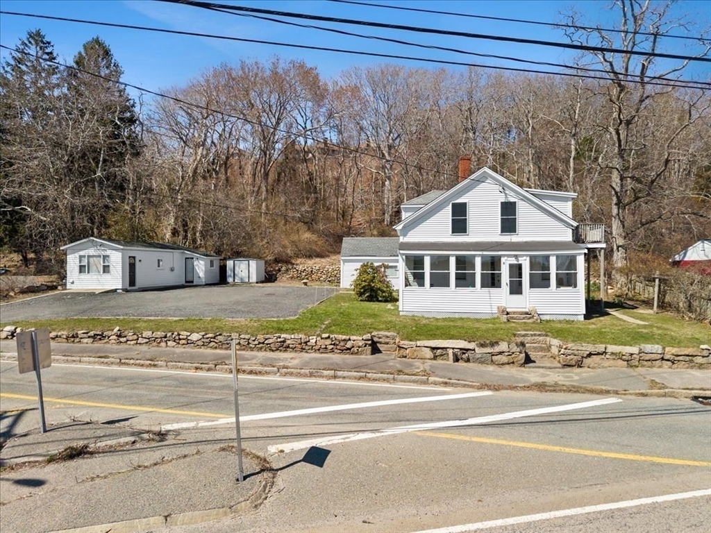 8 Herring Pond Road Bourne, MA 02532 - Photo 4 of 42 a front view of a house with a yard