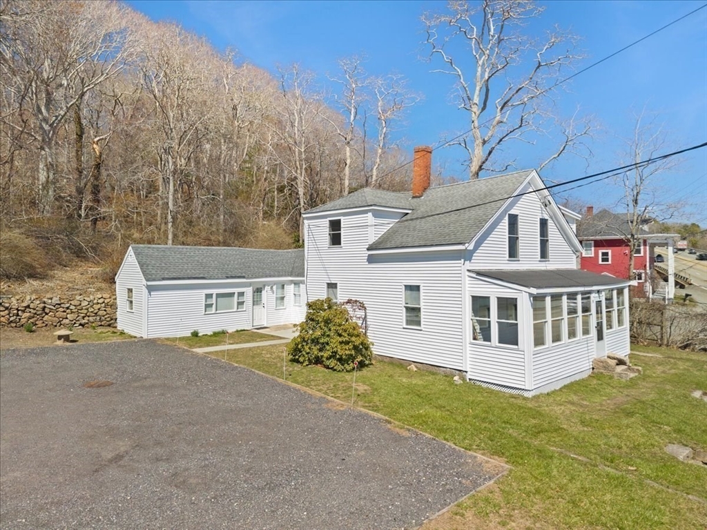 8 Herring Pond Road Bourne, MA 02532 - Photo 6 of 42 a view of a white house with a yard and fence