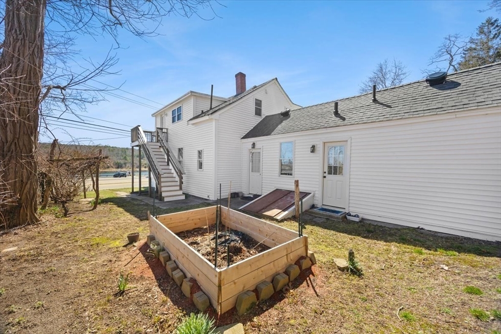8 Herring Pond Road Bourne, MA 02532 - Photo 9 of 42 a front view of a house with a yard