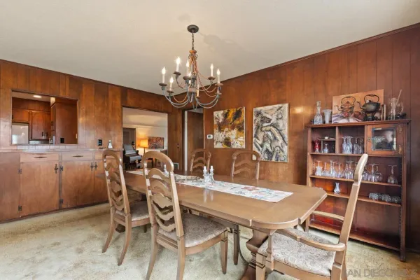 a view of a dining room with furniture and chandelier