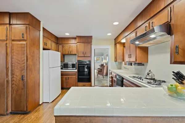 a kitchen with stainless steel appliances granite countertop a refrigerator and a sink