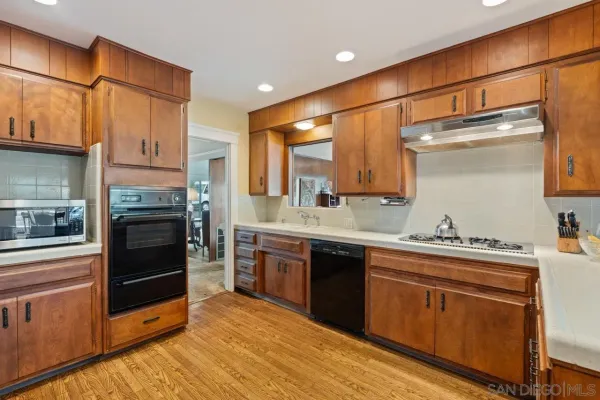 a kitchen with stainless steel appliances a stove sink and cabinets