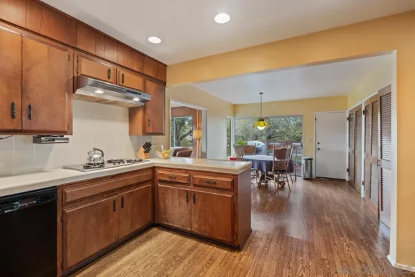 a kitchen with a sink cabinets and wooden floor