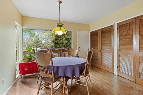 a view of a dining room with furniture window and wooden floor