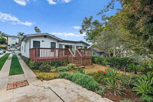 a view of a house with a small yard and plants