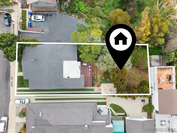 an aerial view of a house with garden space and swimming pool