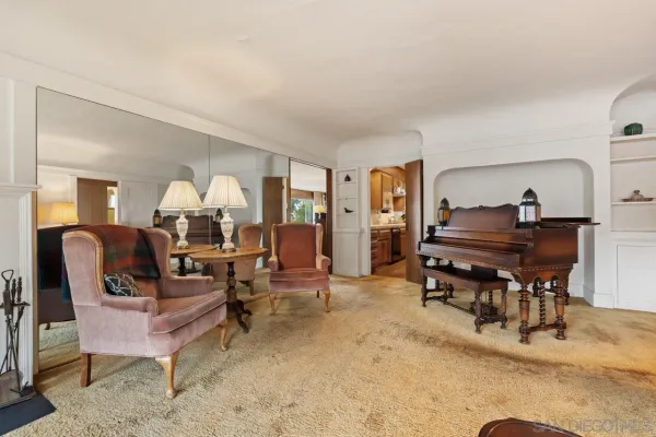 a living room with furniture and a piano