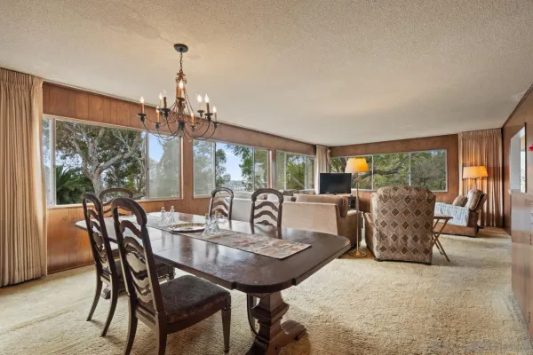 a view of a dining room with furniture wooden floor and chandelier