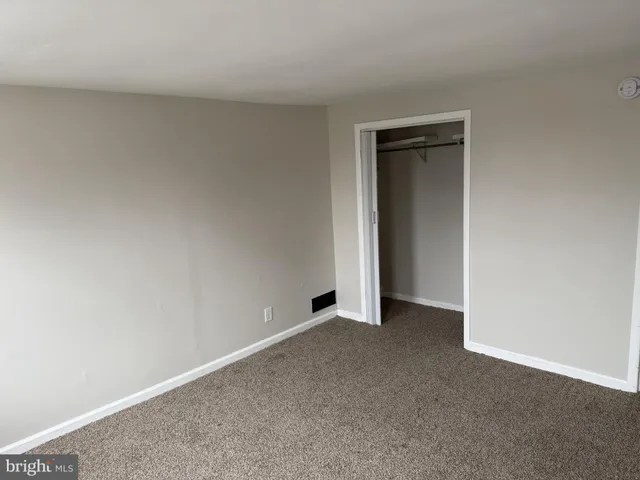 a view of an empty room and closet