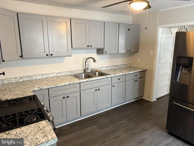 a kitchen with a sink stove and cabinets