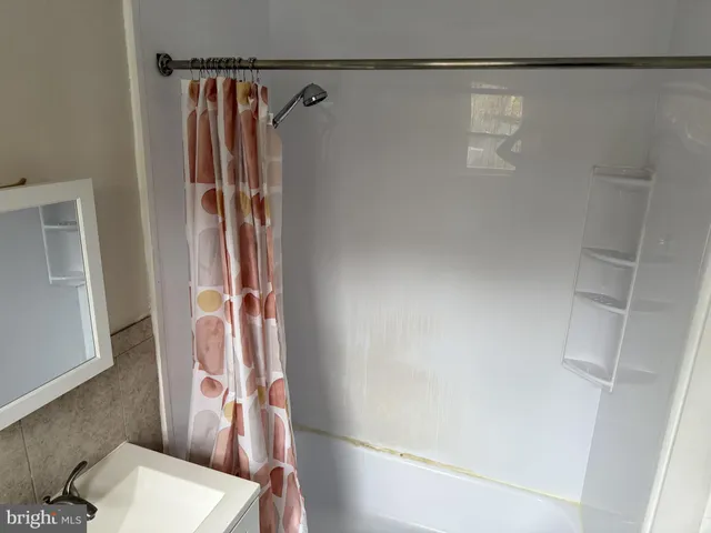 a bathroom with a shower and a toilet