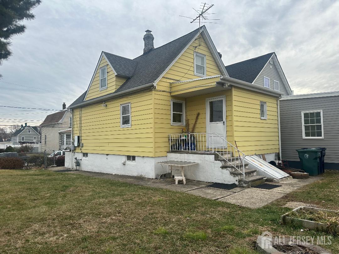 653 Raritan Avenue Perth Amboy, NJ 08861 - Photo 3 of 3 a view of a white house with a yard