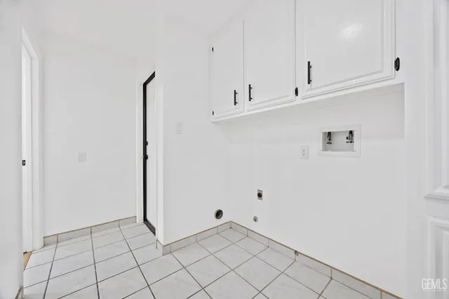 a view of kitchen with white cabinets