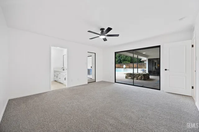 a view of a livingroom with a ceiling fan and window