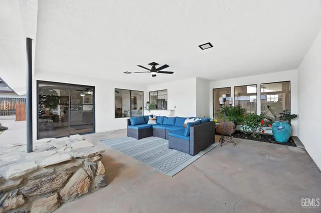 a living room with furniture large window and a chandelier