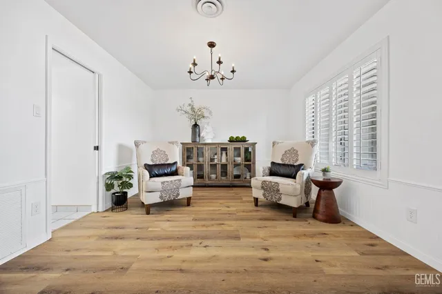 a living room with furniture chandelier and a window