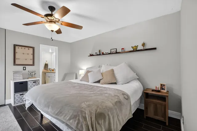 a bedroom with a bed and a chandelier