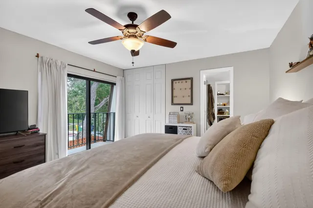 a bedroom with a large bed and a flat screen tv