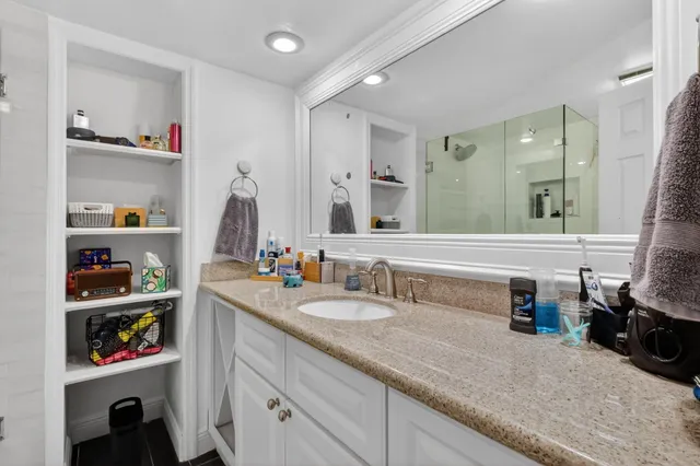 a bathroom with a double vanity sink and a mirror