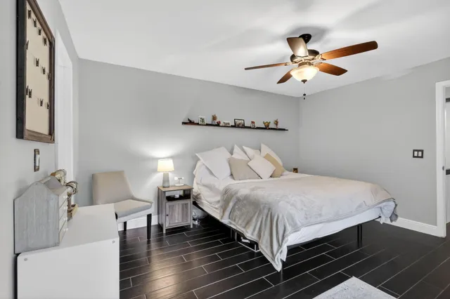 a bedroom with bed and a chandelier