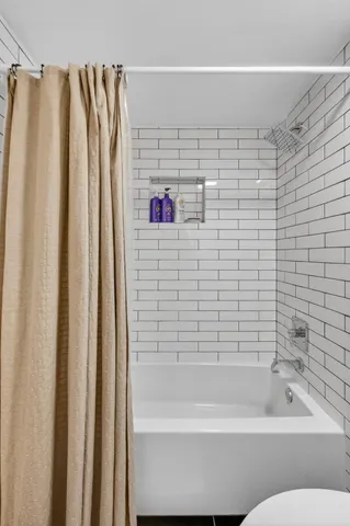 a bathroom with a shower and a bathtub
