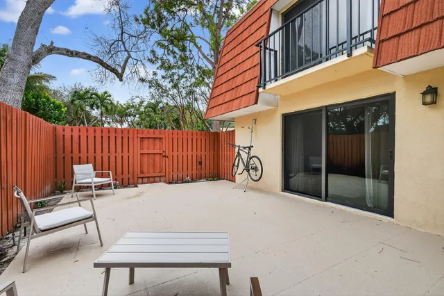 a backyard of a house with table and chairs