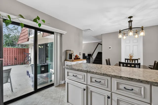 a bathroom with a granite countertop sink a mirror and a bathtub