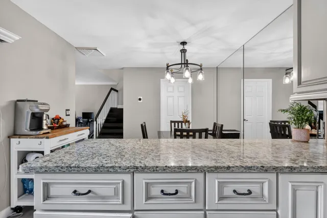a kitchen with granite countertop a sink and center island