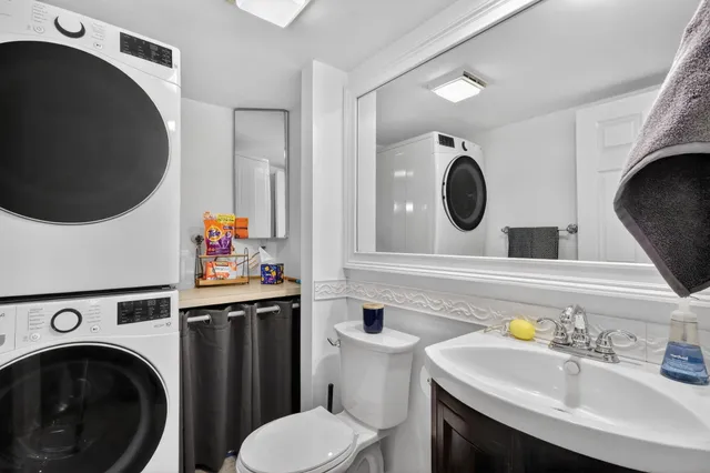 a bathroom with a sink a toilet and a mirror