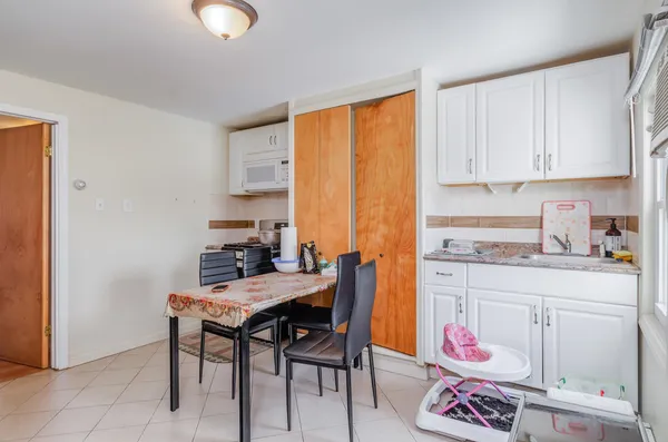a kitchen with a table and chairs in it