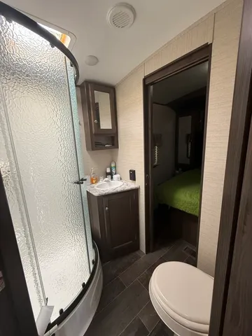 a bathroom with a sink a toilet a mirror and vanity