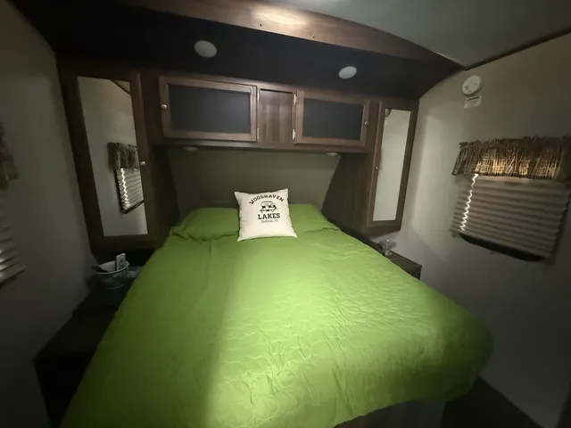 a bed sitting in a bedroom next to a window