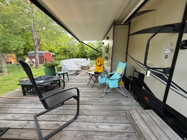 a view of a house with backyard and a tree