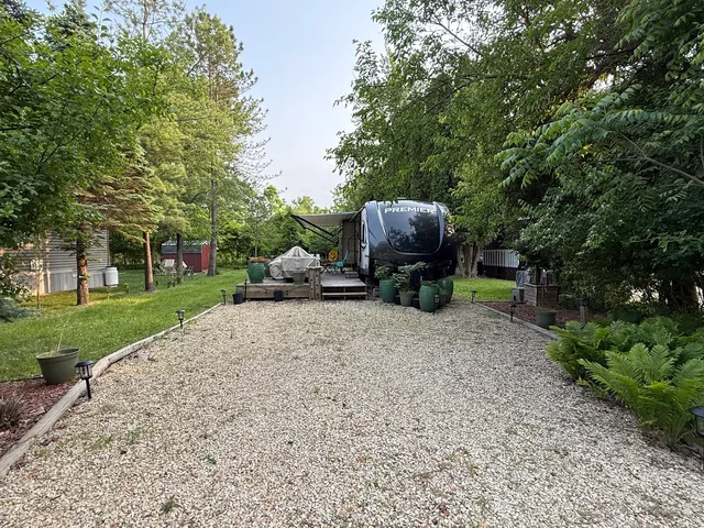 a backyard of a house with barbeque oven table and chairs