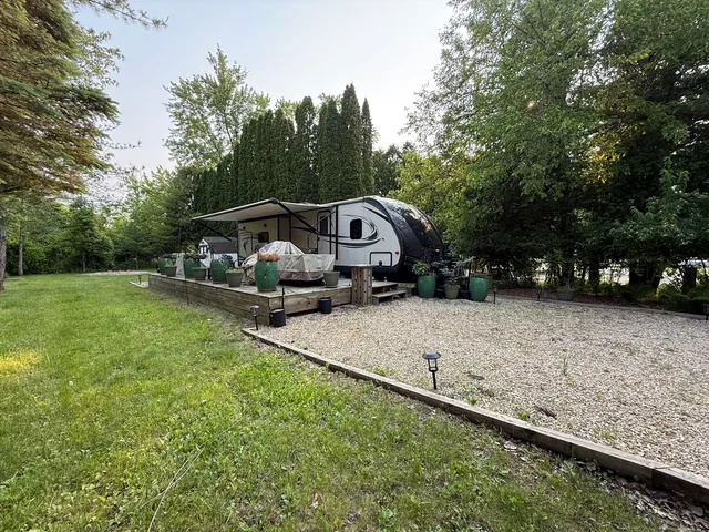 a view of a wooden deck with a yard