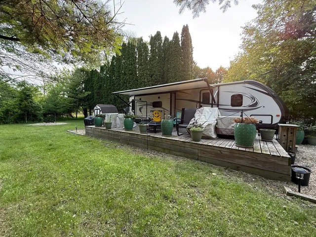 a view of two chairs in the backyard