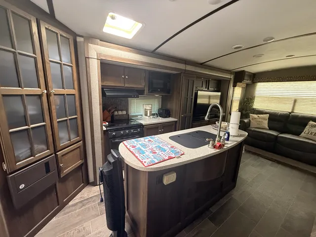 a kitchen with stainless steel appliances granite countertop a sink and a refrigerator