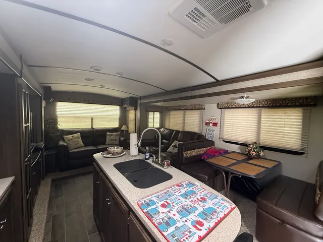 a kitchen with kitchen island granite countertop a sink stove and cabinets