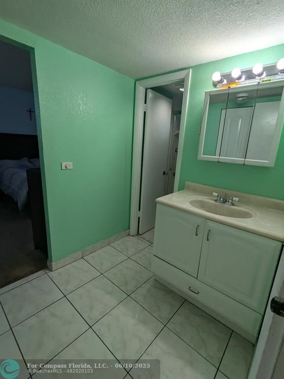 3130 Holiday Springs Boulevard, Unit 204 Margate, FL 33063 - Photo 17 of 32 a bathroom with a sink and a mirror