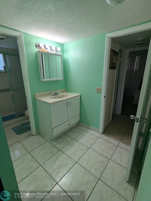 3130 Holiday Springs Boulevard, Unit 204 Margate, FL 33063 - Photo 19 of 32 a bathroom with a sink a toilet and mirror