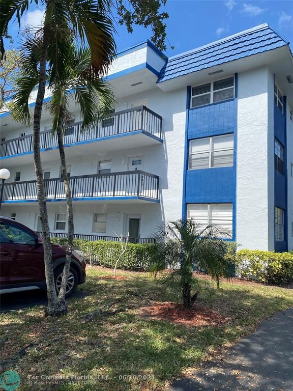 3130 Holiday Springs Boulevard, Unit 204 Margate, FL 33063 - Photo 26 of 32 a front view of a house with a yard