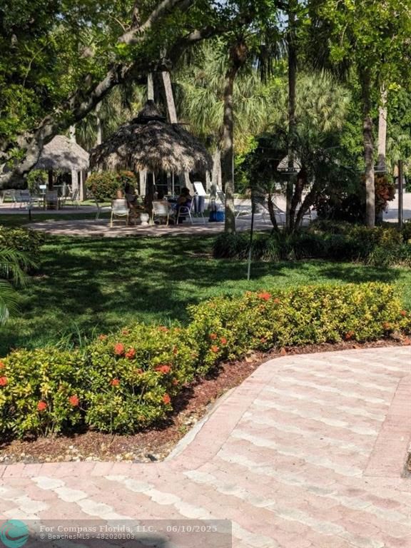 3130 Holiday Springs Boulevard, Unit 204 Margate, FL 33063 - Photo 28 of 32 a front view of a house with a garden
