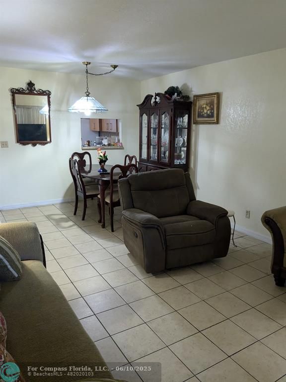 3130 Holiday Springs Boulevard, Unit 204 Margate, FL 33063 - Photo 7 of 32 a living room with furniture and a flat screen tv