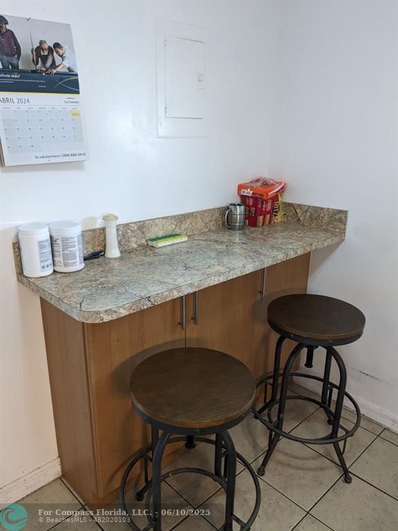 3130 Holiday Springs Boulevard, Unit 204 Margate, FL 33063 - Photo 9 of 32 a view of table chairs and cabinets