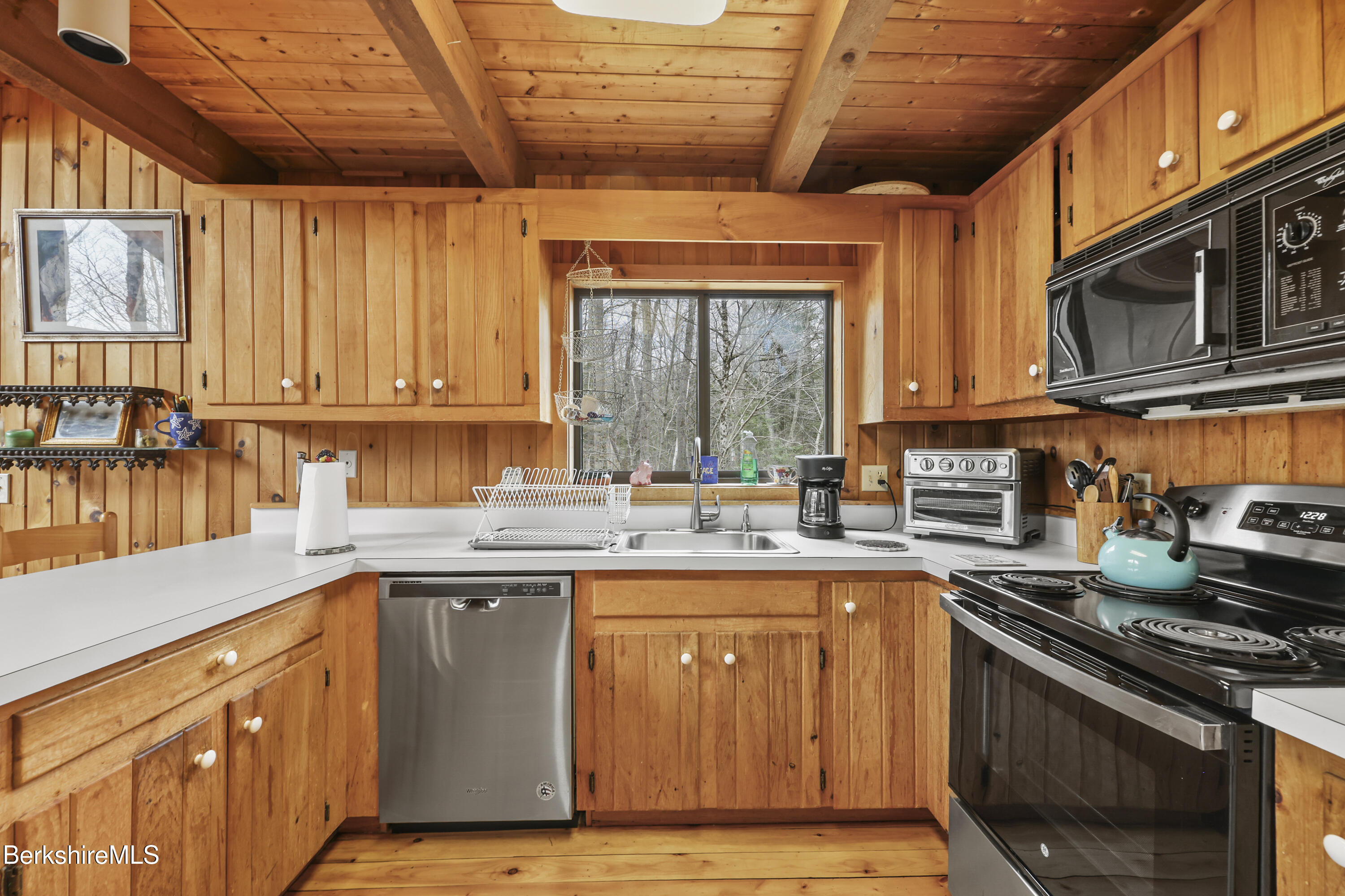 125 Town Hill Road Sandisfield, MA 01255 - Photo 11 of 42 a kitchen with stainless steel appliances granite countertop a stove a sink dishwasher and cabinets with wooden floor